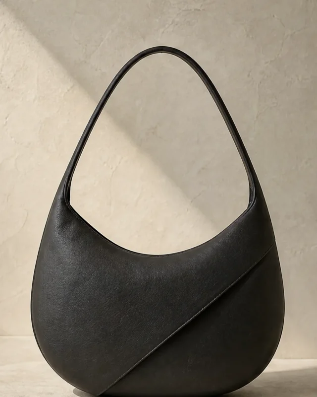 Aural Crescent Shoulder Bag in ink, front view
