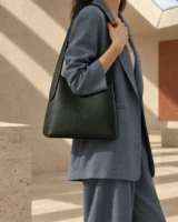 Threshold Shoulder Bag in forest worn with a tailored outfit