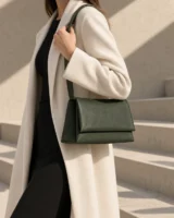 Sill Ledge Shoulder Bag in forest worn with a tailored outfit