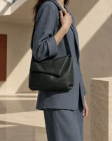 Tuckline Shoulder Bag in ink worn with a tailored outfit