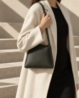 Slope Shoulder Bag in deep forest worn with a tailored outfit