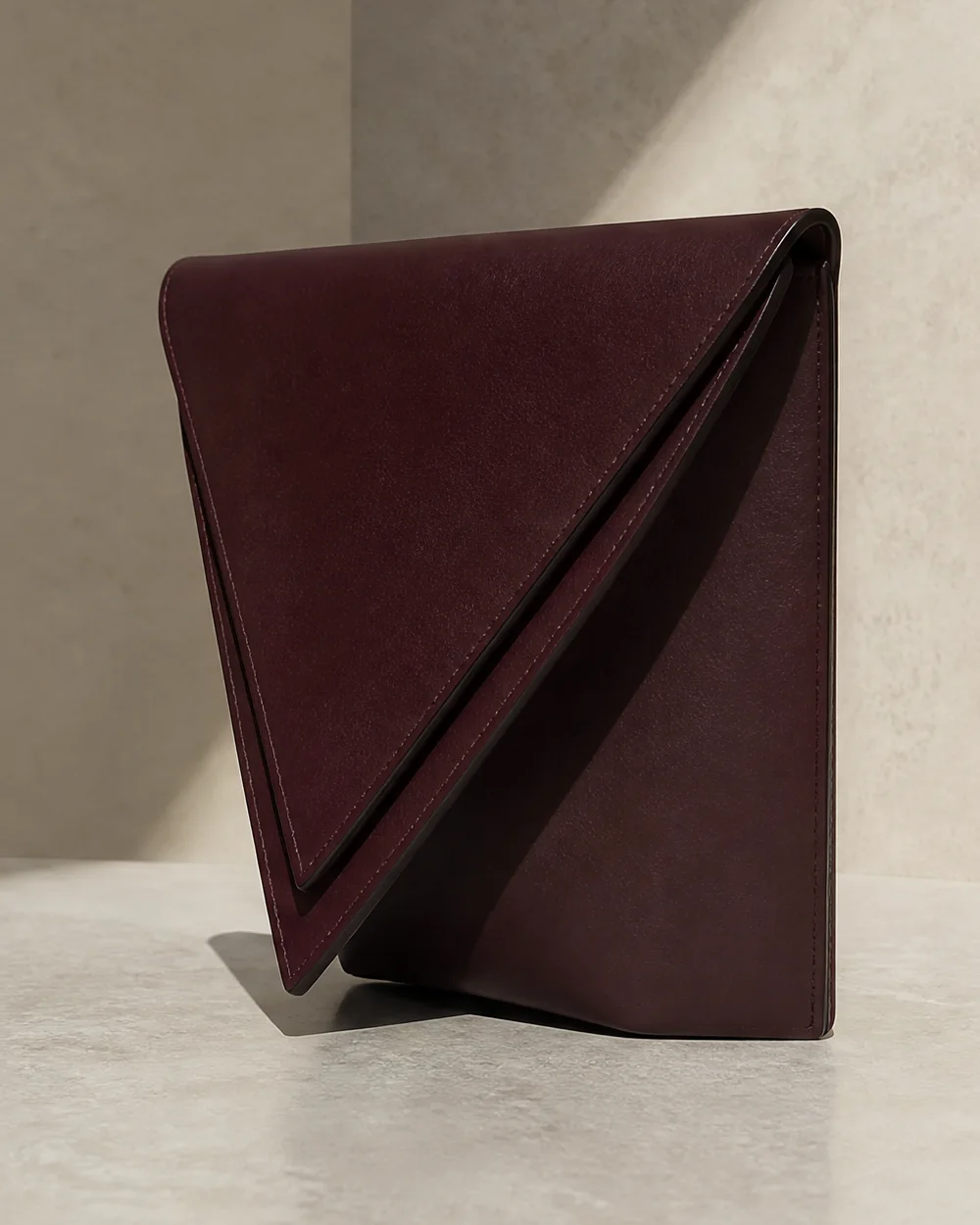 Lamina Double-Edge Clutch in oxblood, side view