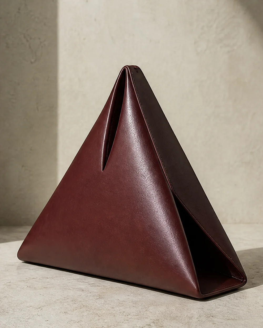 Apex Triangle Clutch in oxblood, side view