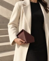Gable Roof Clutch in oxblood worn with a tailored outfit