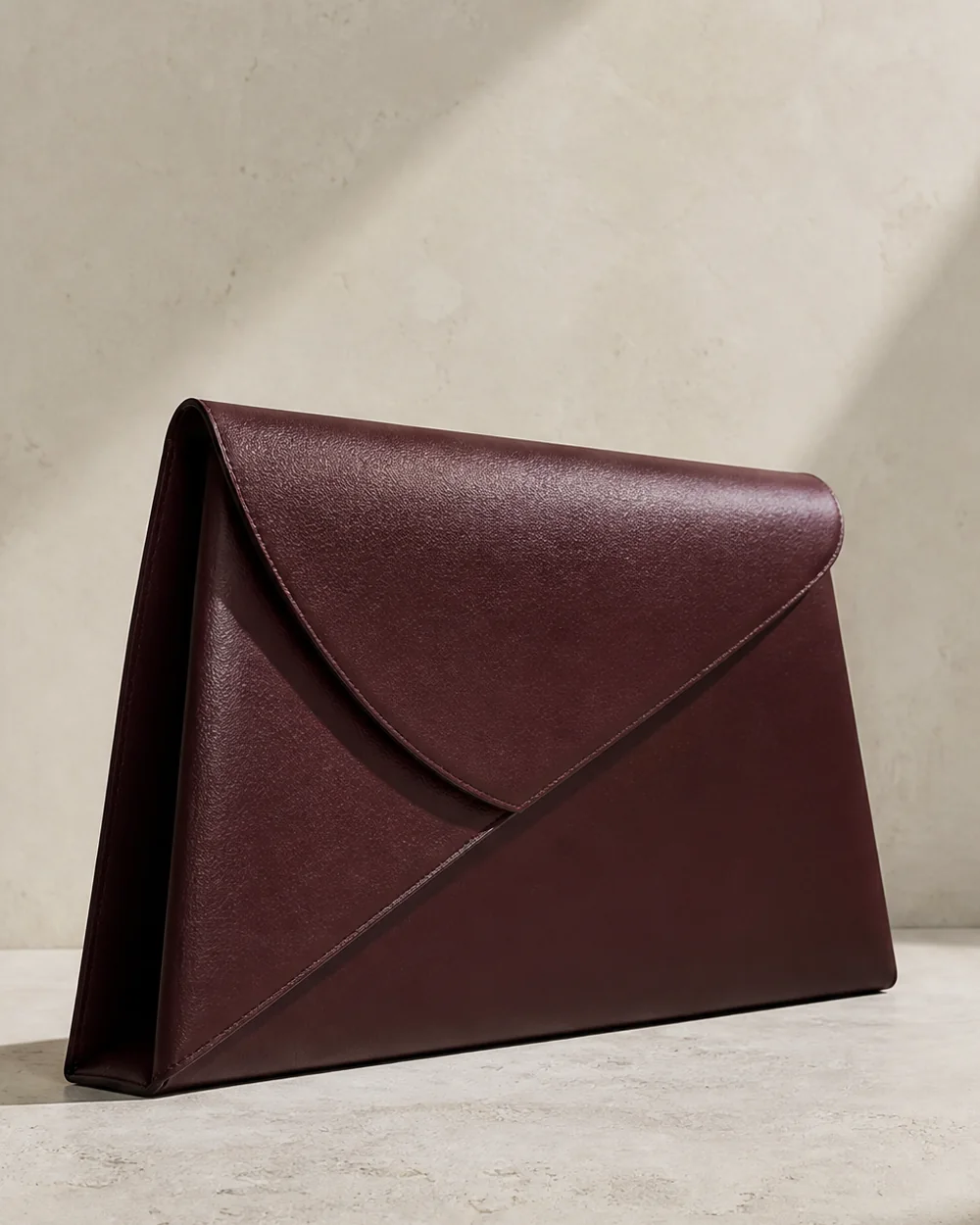 Parabola Envelope Clutch in oxblood, side view
