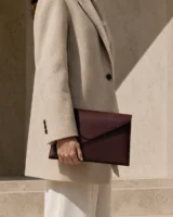 Parabola Envelope Clutch in oxblood worn with a tailored outfit