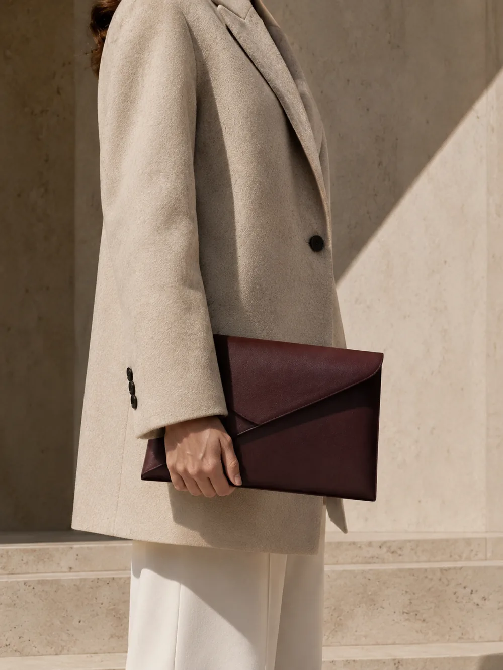 Parabola Envelope Clutch in oxblood worn with a tailored outfit
