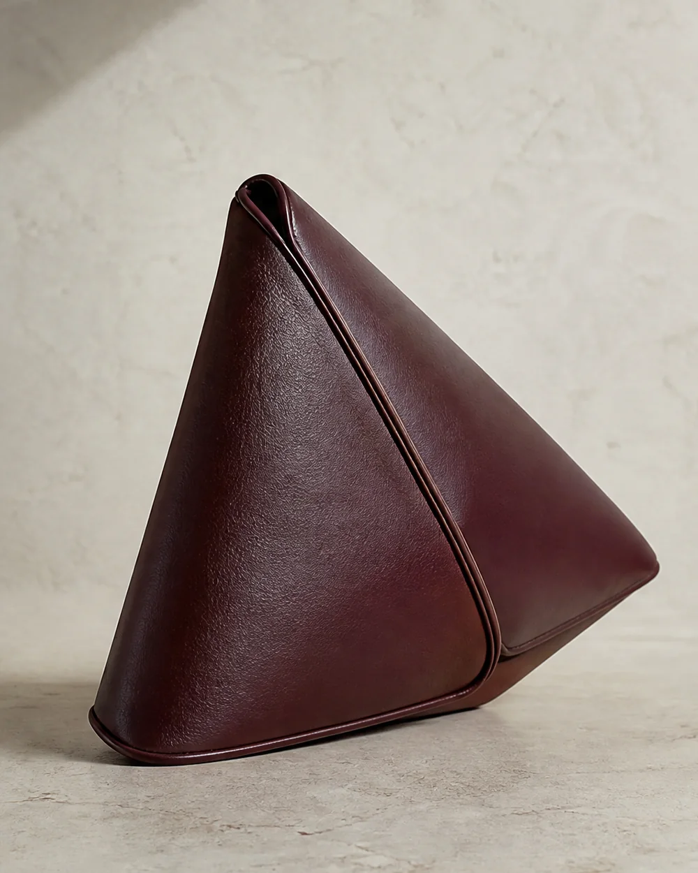Edgework Triangle Clutch in oxblood, side view