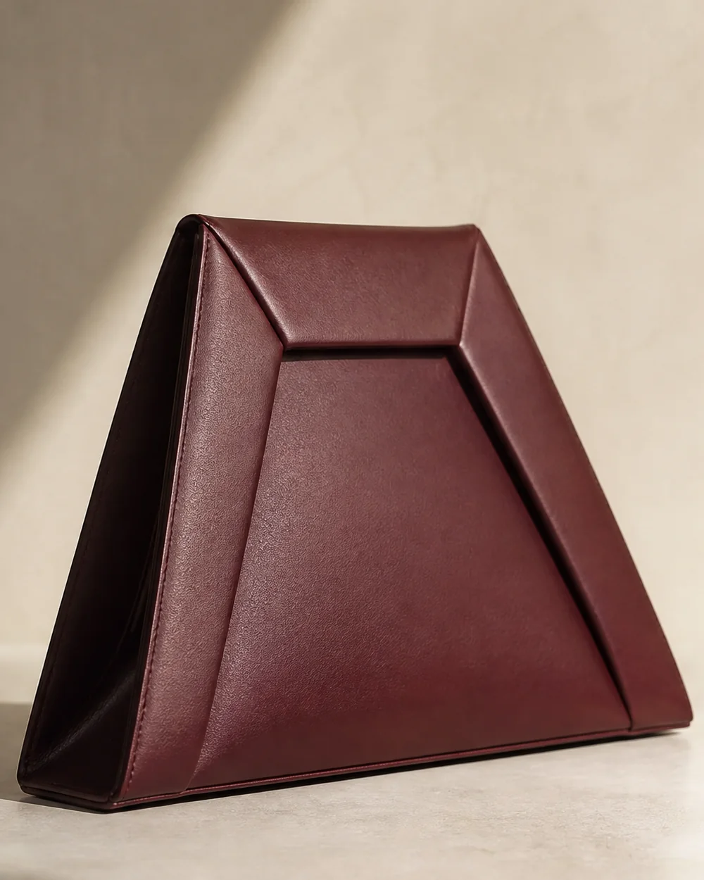 Inlet Trapezoid Clutch in oxblood, side view
