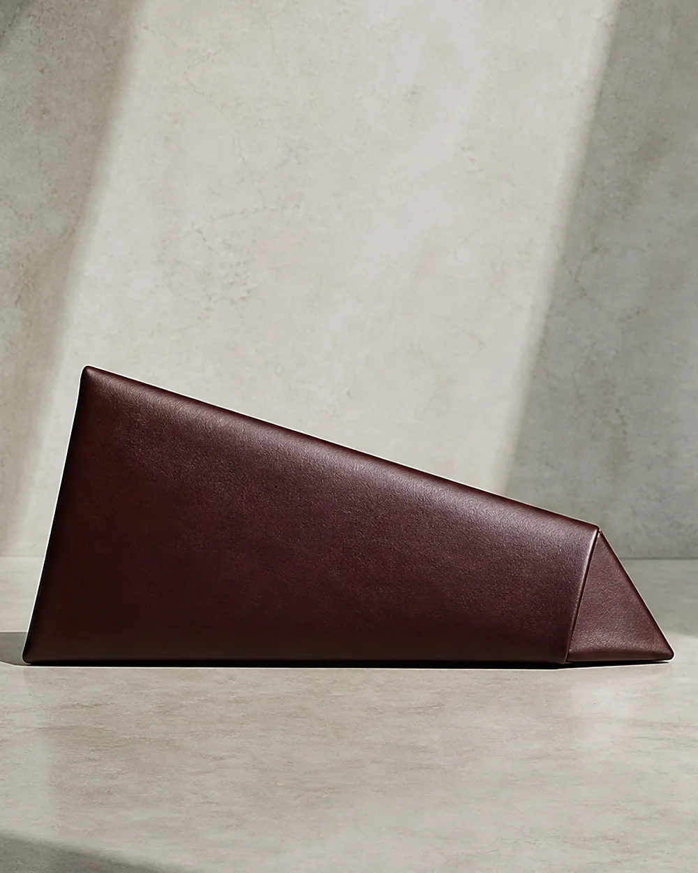 Lucent Wedge Clutch in oxblood, front view