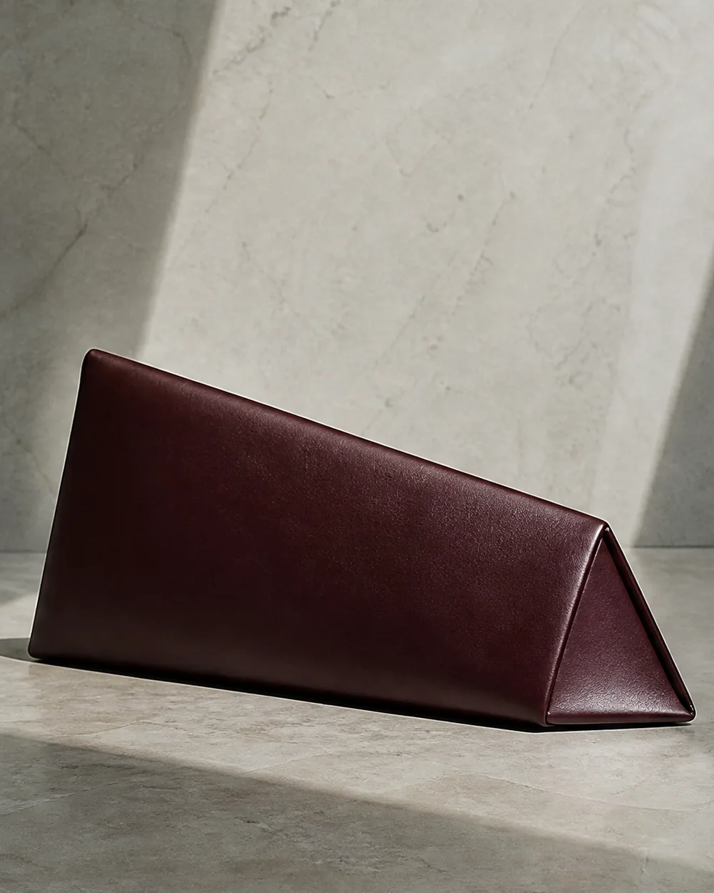 Lucent Wedge Clutch in oxblood, side view