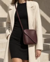 Turn Crossbody in plum worn with a tailored outfit