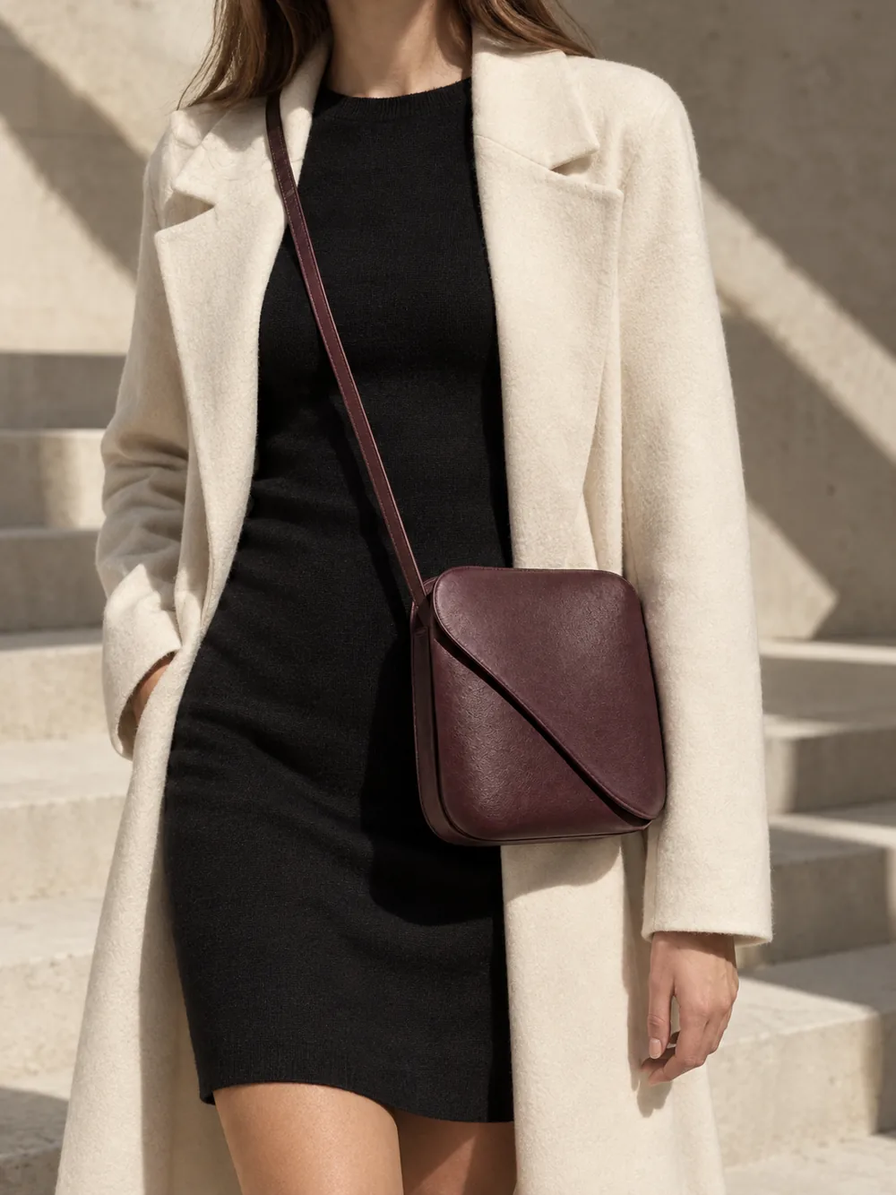 Turn Crossbody in plum worn with a tailored outfit