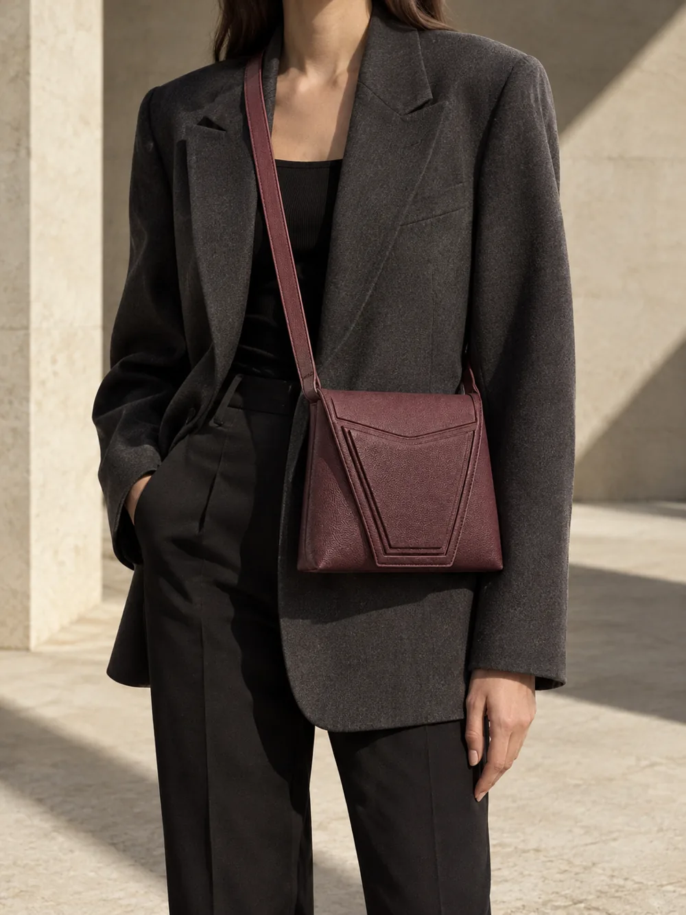 Angle Nested Crossbody in plum worn with a tailored outfit