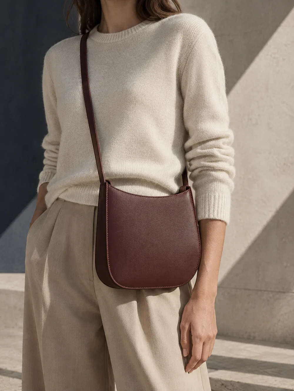 Silhouette Crossbody in oxblood worn with a tailored outfit