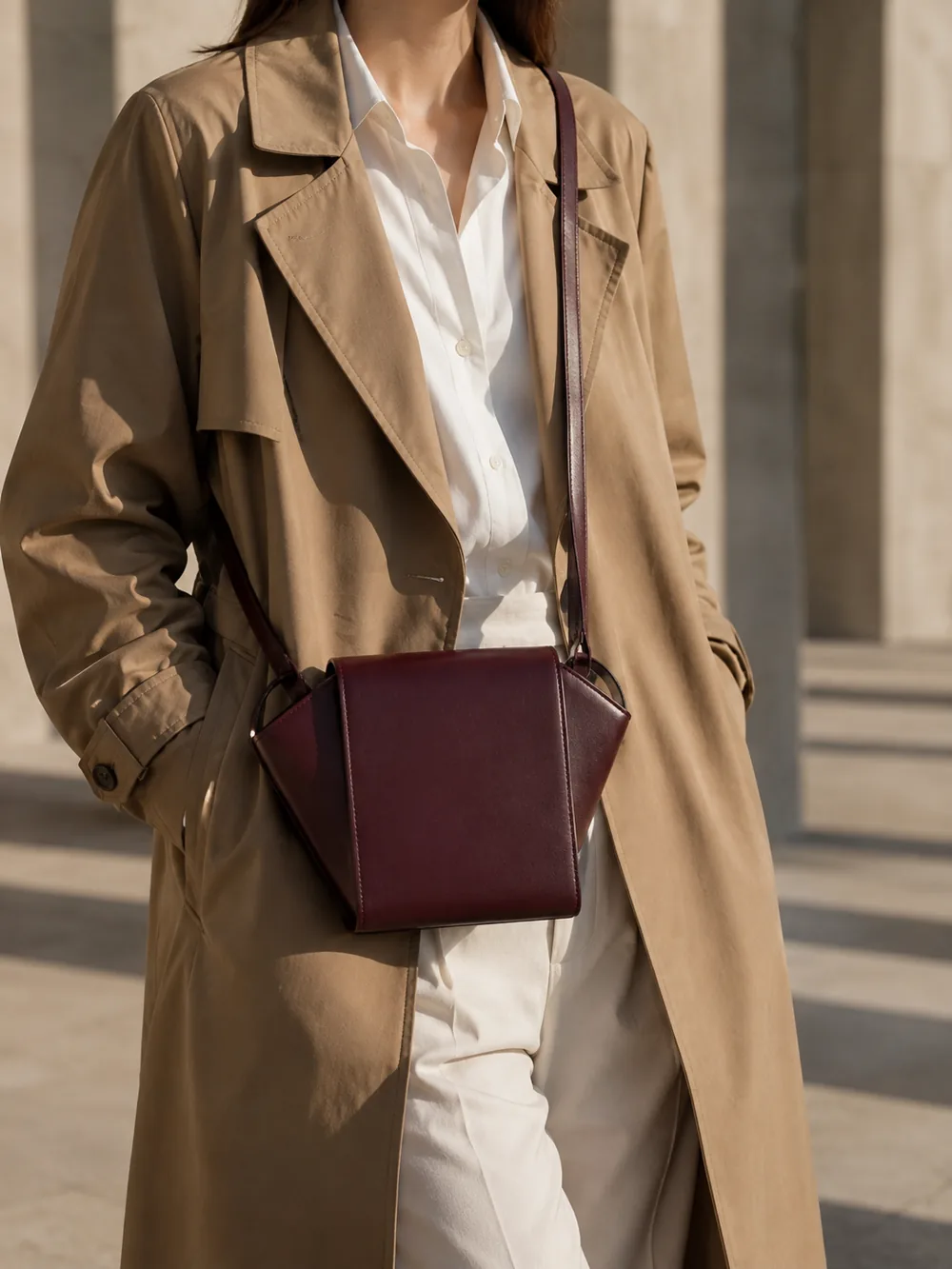 Graft Crossbody in plum worn with a tailored outfit