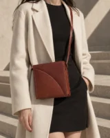 Bracket Crossbody in sienna worn with a tailored outfit