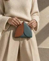 Leaf Pouch in terracotta / teal worn with a tailored outfit