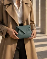 Billow Pouch in teal worn with a tailored outfit