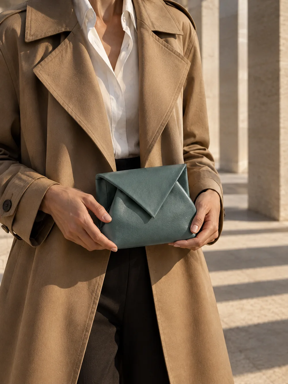 Billow Pouch in teal worn with a tailored outfit