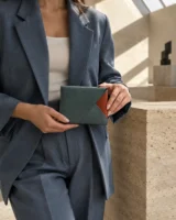 Corner Wrap Pouch in teal / terracotta worn with a tailored outfit