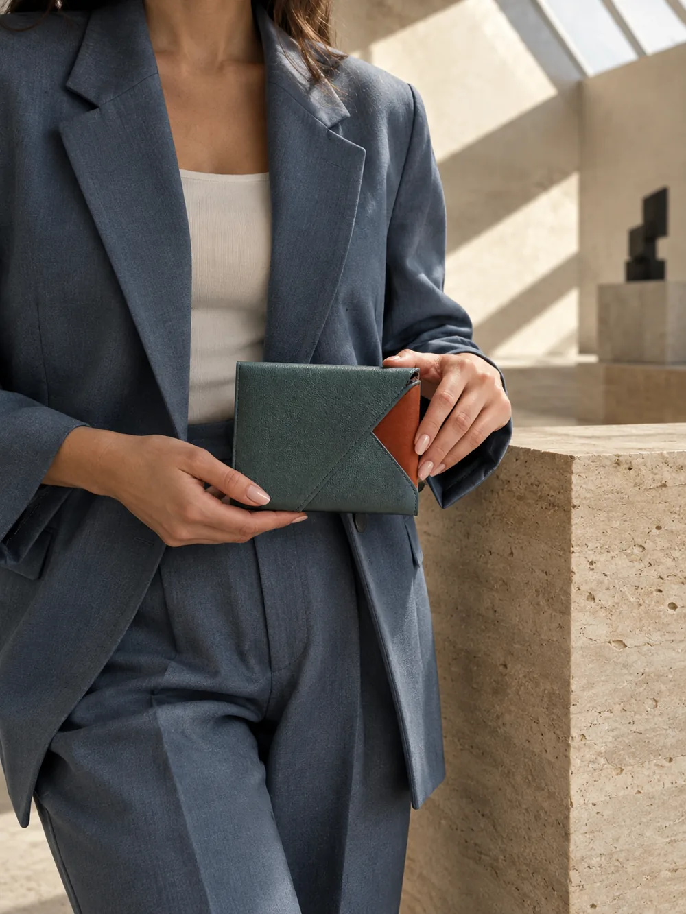 Corner Wrap Pouch in teal / terracotta worn with a tailored outfit