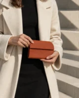 Fillet Coin Pouch in terracotta worn with a tailored outfit
