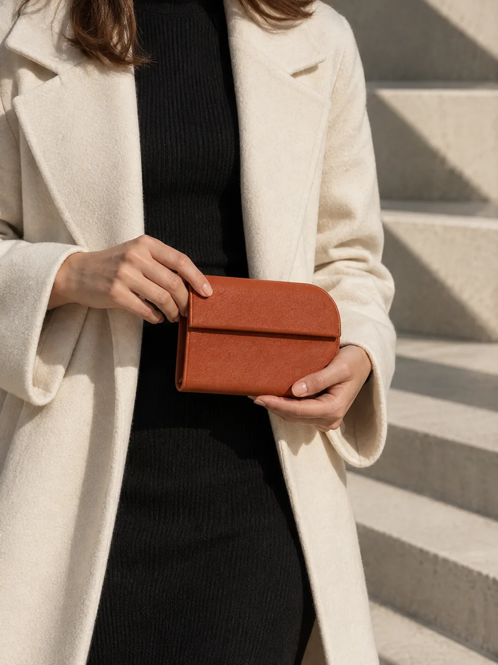 Fillet Coin Pouch in terracotta worn with a tailored outfit