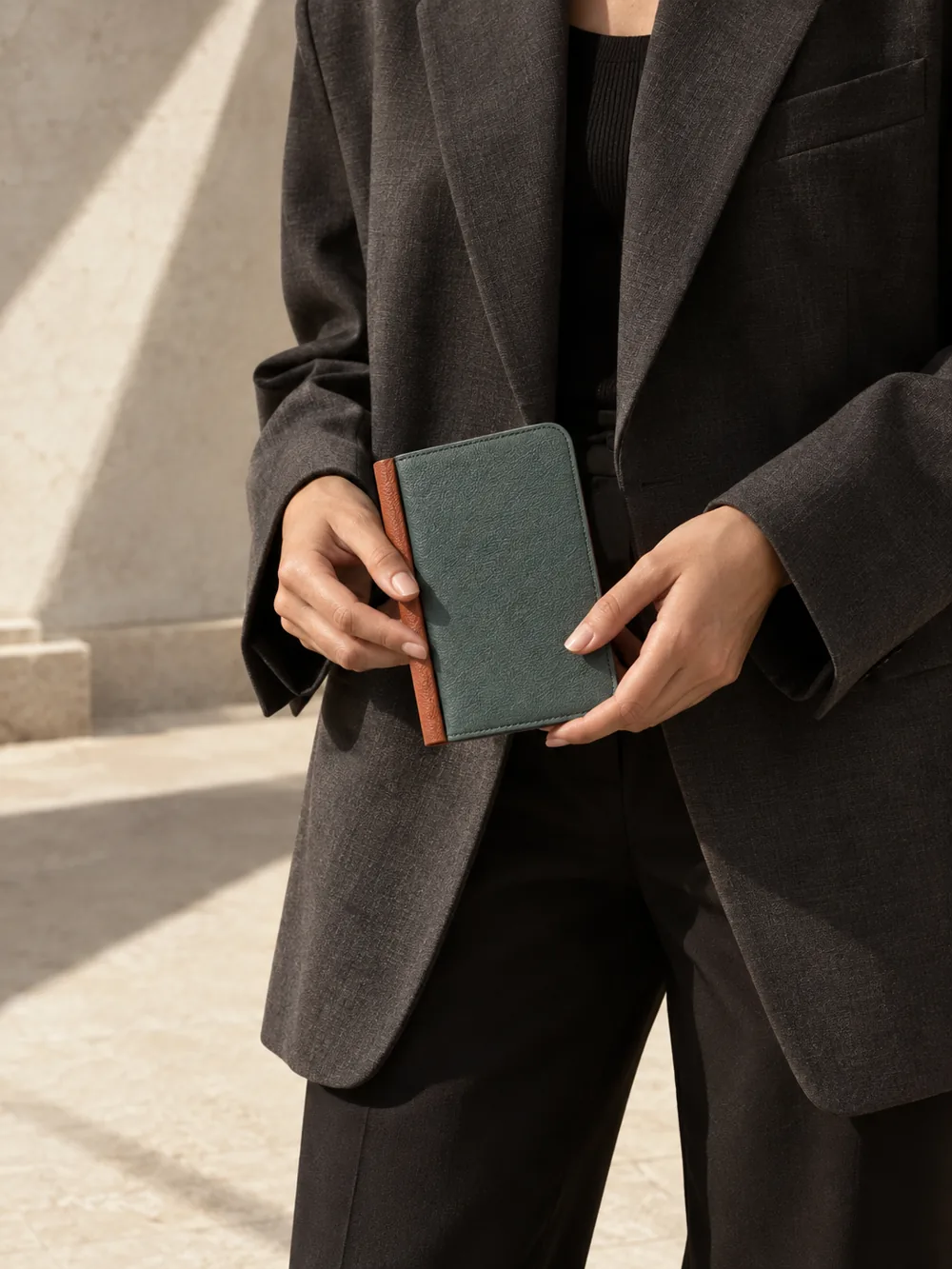 Foldbook Wallet in teal worn with a tailored outfit