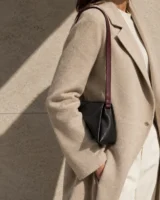Continuity Strap in oxblood worn with a tailored outfit
